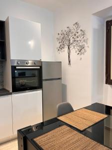 Il comprend une cuisine équipée d'un réfrigérateur et d'une table avec une chaise. dans l'établissement Loft Delle Scalette, à Nepi