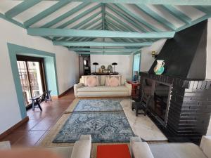 a living room with a couch and a fireplace at Casa Cuqui in Orgaz