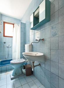 a bathroom with a sink and a toilet at Maribela Apartments in Trogir