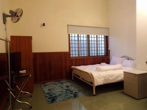 a bedroom with a bed and a window at Dimocrata in Phnom Penh