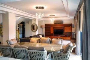 a living room with a table and chairs at LUXURY VILLA FOUR FOURLEX (YALOVA) in Termal