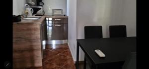 a kitchen with a counter and a table with a remote control at Vikendica Nika in Rab +1 photo
