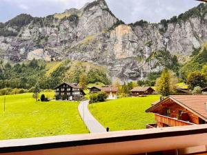 a view of a village with a mountain in the background at Waterfall View in Kandersteg