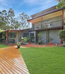 a house with a green lawn in front of it at Bushland retreat in Gold Coast