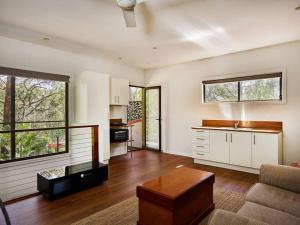 a living room with a couch and a table at Bushland retreat in Gold Coast