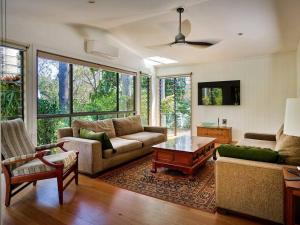 a living room with two couches and a coffee table at Bushland retreat in Gold Coast