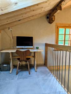 een bureau met een computer in een kamer bij Chalet Grittelihus, large bathroom, Lots of living space, nahe Interlaken in Diemtigen