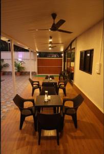 a group of tables and chairs in a room at SAVI 4BHK VILLA ALIBAUG in Alibaug
