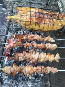 a bunch of meat and shrimp on a grill at Lagom Village (Glamping Site) in Hanoi