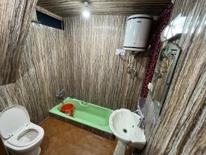 a bathroom with a toilet and a sink and a tub at New Silver Jubilee Heritage Group Of Houseboats in Srinagar