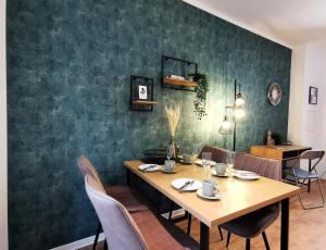 a dining room with a table and chairs at BohnApartments Studio M City - Domplatz - WLAN - Vollausstattung in Erfurt +9 photos