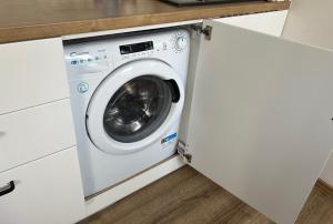 a washing machine in a white laundry room at Historic Center Brno Apartment in Brno