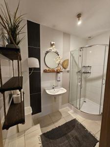 a bathroom with a shower and a sink and a mirror at Deja Vu Hostel in Warsaw +111 photos