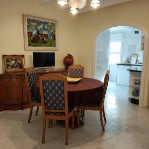 a dining room with a table and chairs and a television at Apartments in a "VILLA VISTA JAVEA" in Jávea