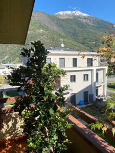 a view from the balcony of a white building with a mountain at the AllSun in Tirano