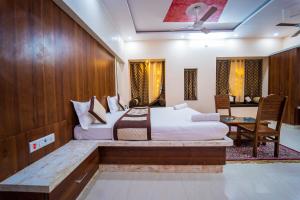 1 dormitorio con 2 camas, mesa y escritorio en Hotel Ajeet Palace, en Jaisalmer