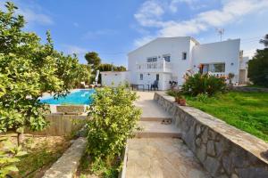 a villa with a swimming pool and a house at Apartments in a "VILLA VISTA JAVEA" in Jávea
