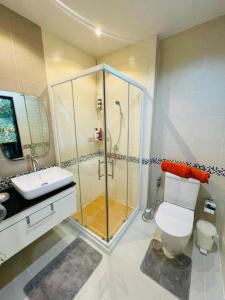 een badkamer met een douche, een toilet en een wastafel bij Brand New Naithon Condo C411 in Nai Thon Beach