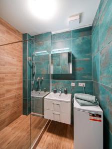 a bathroom with a glass shower and a sink at TRIO apartment in Piešťany