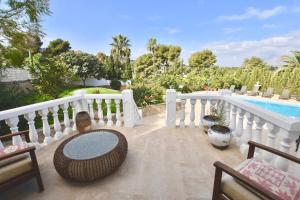 a patio with a white fence and a swimming pool at Apartments in a "VILLA VISTA JAVEA" in Jávea