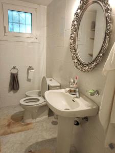 a bathroom with a toilet and a sink and a mirror at Apartments in a "VILLA VISTA JAVEA" in Jávea
