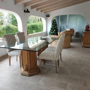 a dining room with a glass table and chairs at Apartments in a "VILLA VISTA JAVEA" in Jávea