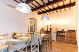 a kitchen and dining room with a long table and chairs at Can Roca Nou in Mahón