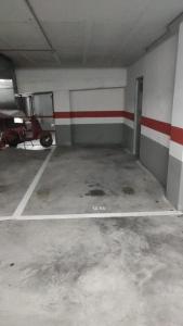 un garage vuoto con una moto parcheggiata in esso di milla sonsuites a O Milladoiro