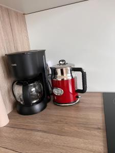 a red and black coffee maker sitting on a counter at Gäste-, Handwerkerzimmer in Rosenfeld
