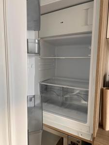 an empty refrigerator with its door open and its empty drawer at Gäste-, Handwerkerzimmer in Rosenfeld