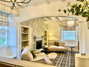 a living room with two couches and a fireplace at Burnley House Bed & Breakfast in Hutton le Hole