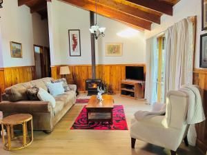 a living room with a couch and a table at Canyon Cottage Majestic view in Blackheath