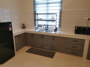 a kitchen with a sink and a window at Anjung Barakah Chalet in Kuala Terengganu