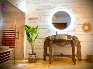 Le Sanglier Amoureux في Érezée: حمام مع حوض ومرآة على الحائط