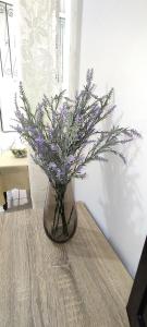 a vase filled with purple flowers sitting on a table at ANASTASIA studio in Kavala