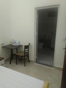een kamer met een tafel en een stoel en een slaapkamer bij Hoàng Bách homestay in Dồng Văn