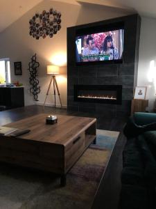 a living room with a fireplace with a tv on top at Modern 2 bedroom town centre apartment in Tamworth in Tamworth