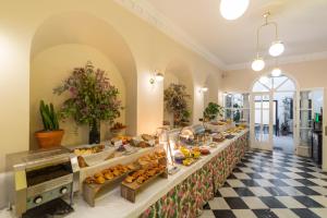 una línea de buffet con mucha comida en Apartamentos Suites Santa Cruz en Sevilla