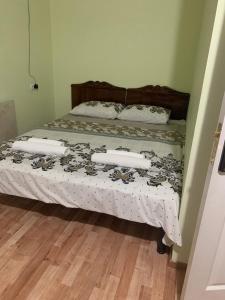 a bed with three pillows on it in a bedroom at ZWIN Apartment 2 in Skole