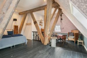 a bedroom with a bed and a table in a room at Inn Friesland in Ternaard