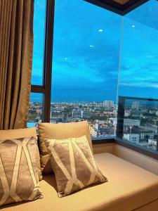 a bed in a room with a large window at Once Pattaya Seaview Condo in Pattaya Central