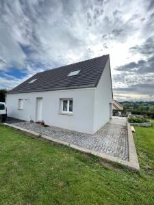 a white house with a black roof at Chambre chez thomas in Glos-sur-Lisieux