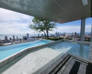 a swimming pool on top of a building with a city skyline at Once Pattaya Seaview Condo in Pattaya