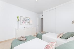 two beds in a room with white walls at Casa Birdie By Kura Homes in Marbella +19 photos