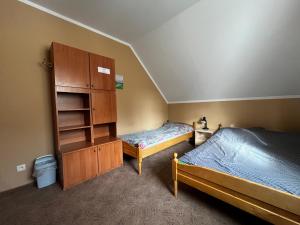 a bedroom with two beds and a cupboard and a bed sqor at Agroturystyka Radzewicz in Wiżajny