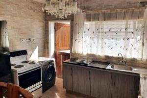 a kitchen with a stove and a sink at Stunning 3-Bed House in Harare in Harare