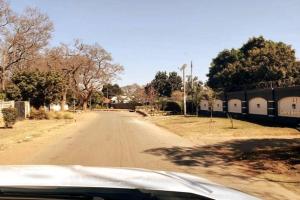 a view of a dirt road from a car at Stunning 3-Bed House in Harare in Harare