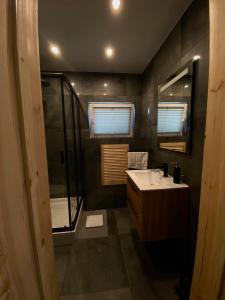a bathroom with a sink and a shower and a mirror at Domki Na Wiosce in Stryszowa +79 photos
