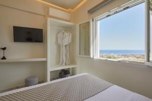 a bedroom with a bed and a window at Artion Luxe Apartment in Vourvoulos