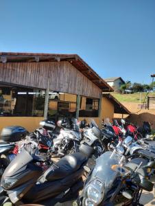 a bunch of motorcycles parked in front of a building at Pousada Quinzitão - O seu local de descanso! in Extrema